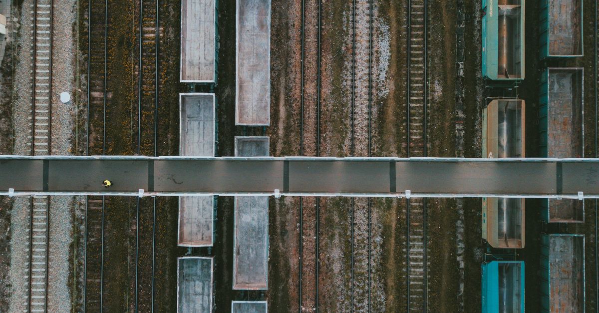 Drone shot of a railway in Poland showcasing cargo trains and tracks from above.